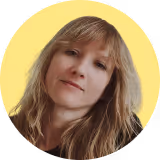 A woman with blonde hair and a black shirt.