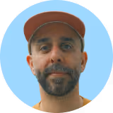 A man wearing a red hat and a yellow shirt.