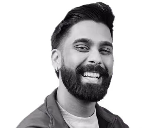 A man with a beard and mustache smiling for the camera.