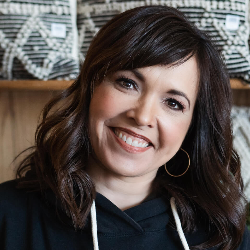 A woman wearing a black hoodie with a white hood.