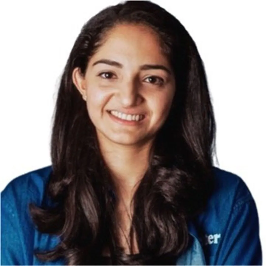 A woman with long hair and a blue shirt smiling.