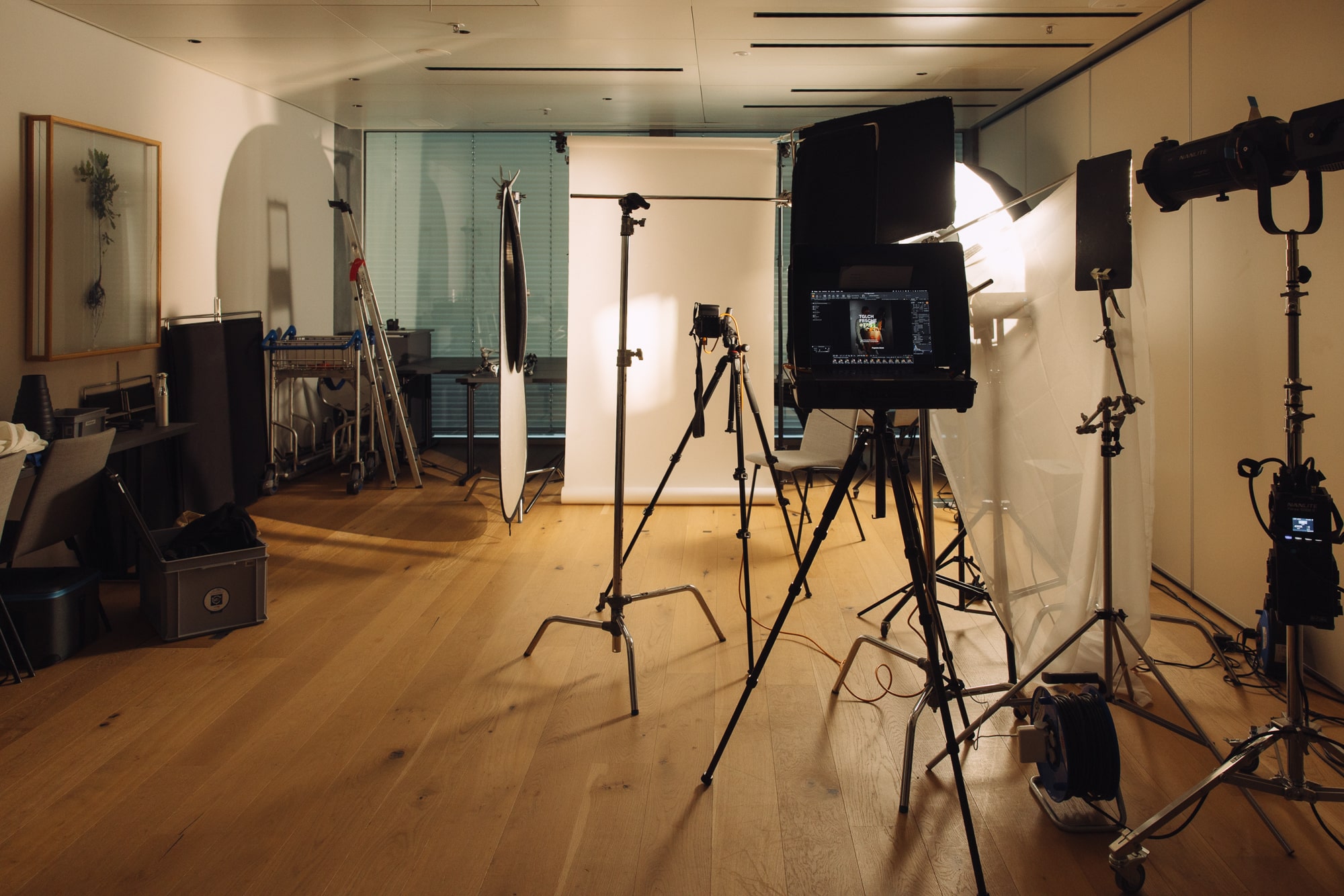 Professional photography studio setup with camera lighting and backdrop equipment for photo shoots.