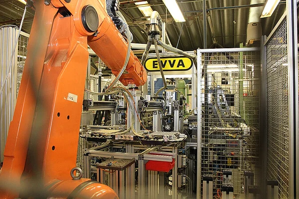 Automated robotic arm in a manufacturing facility, part of a Mevisio success story showcasing digital operational improvements in production.