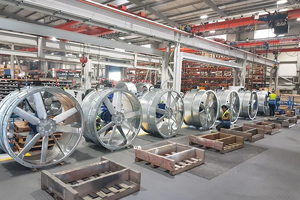 Factory floor with large industrial fans in production.