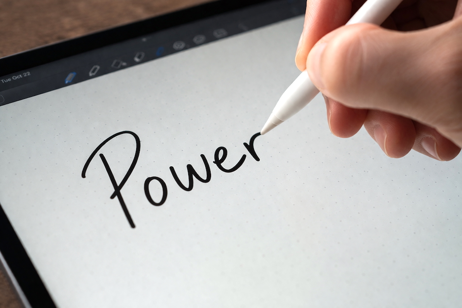 Hand writing the word Power on a tablet