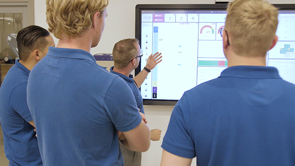 Volvo Bil team reviewing data on a large digital board