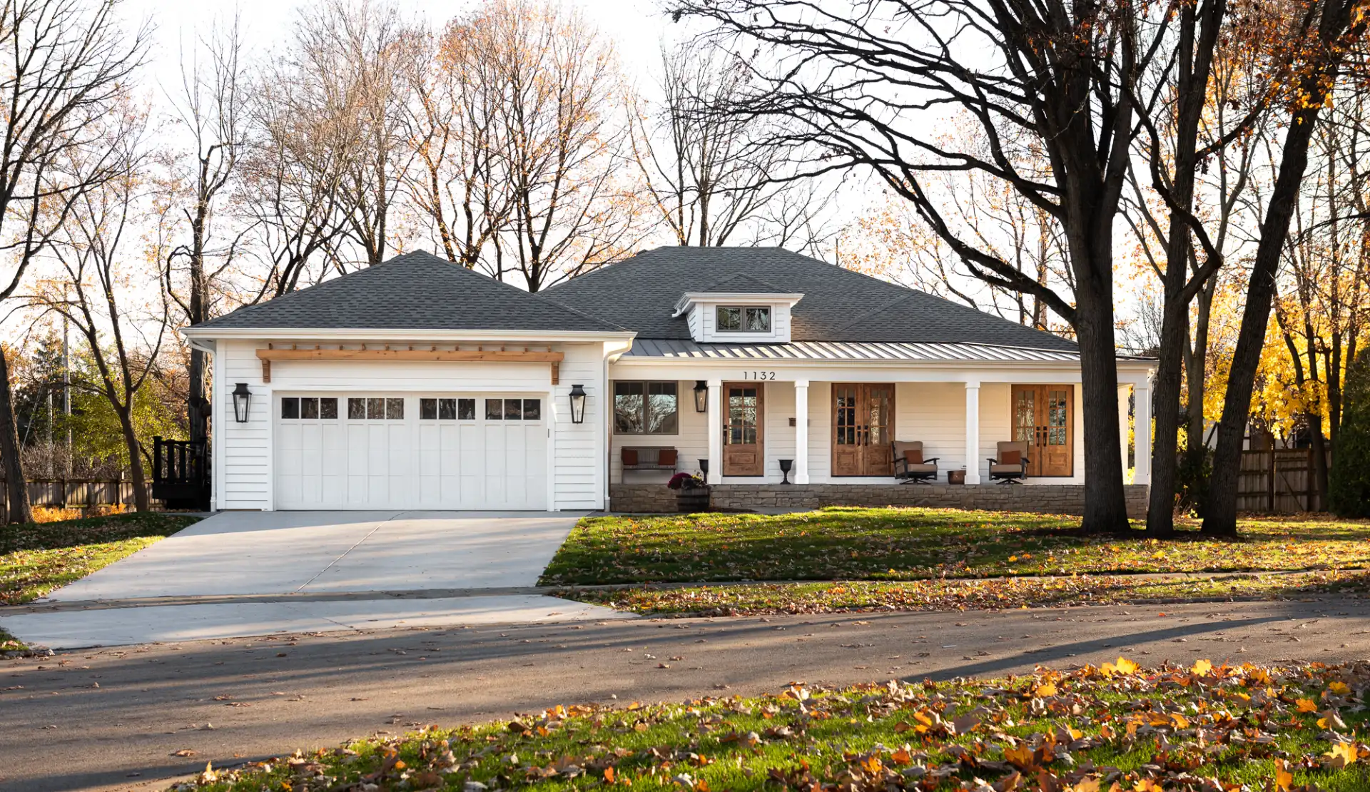 Single-story home with an attached two-car garage, white siding, and a driveway in West Chicagoland