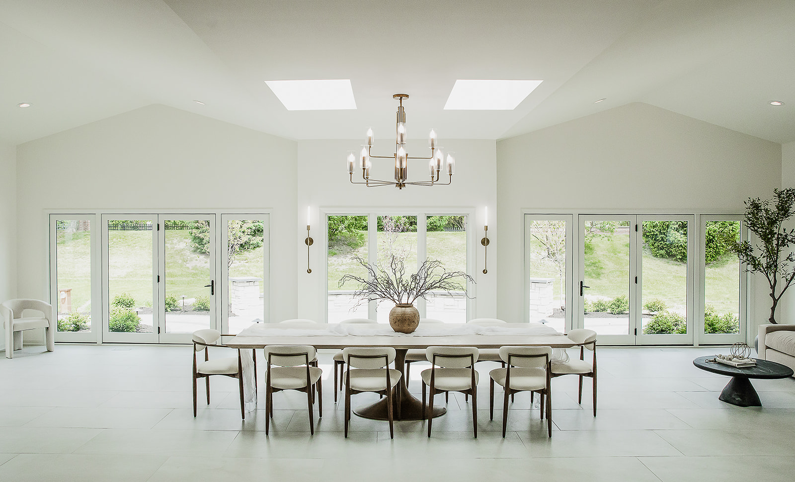 Sunroom addition with skylights, walls of windows, and a dining table in Naperville, IL
