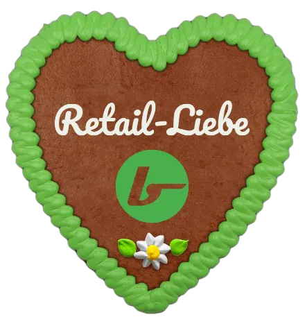 A brown gingerbread heart with a green border, white lettering that reads "Retail Love," and a small flower.