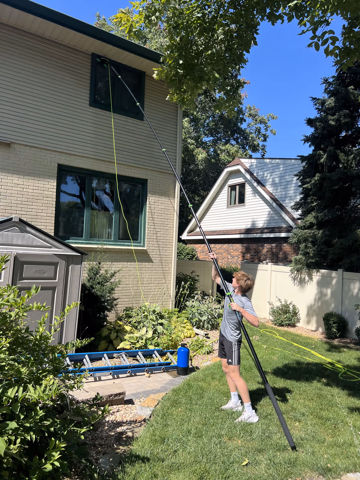 Water-fed pole window cleaning in progress for a Lincoln home.
