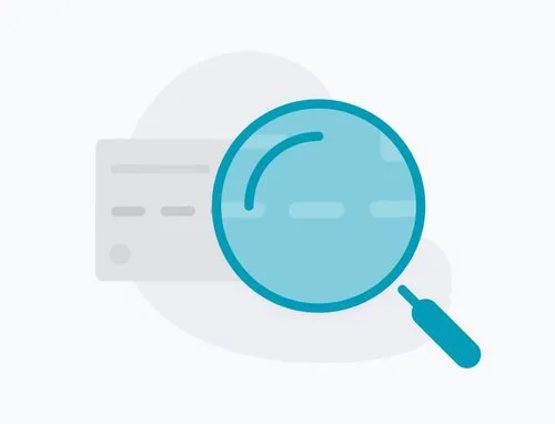 Magnifying glass examining a credit card representing fraud prevention.