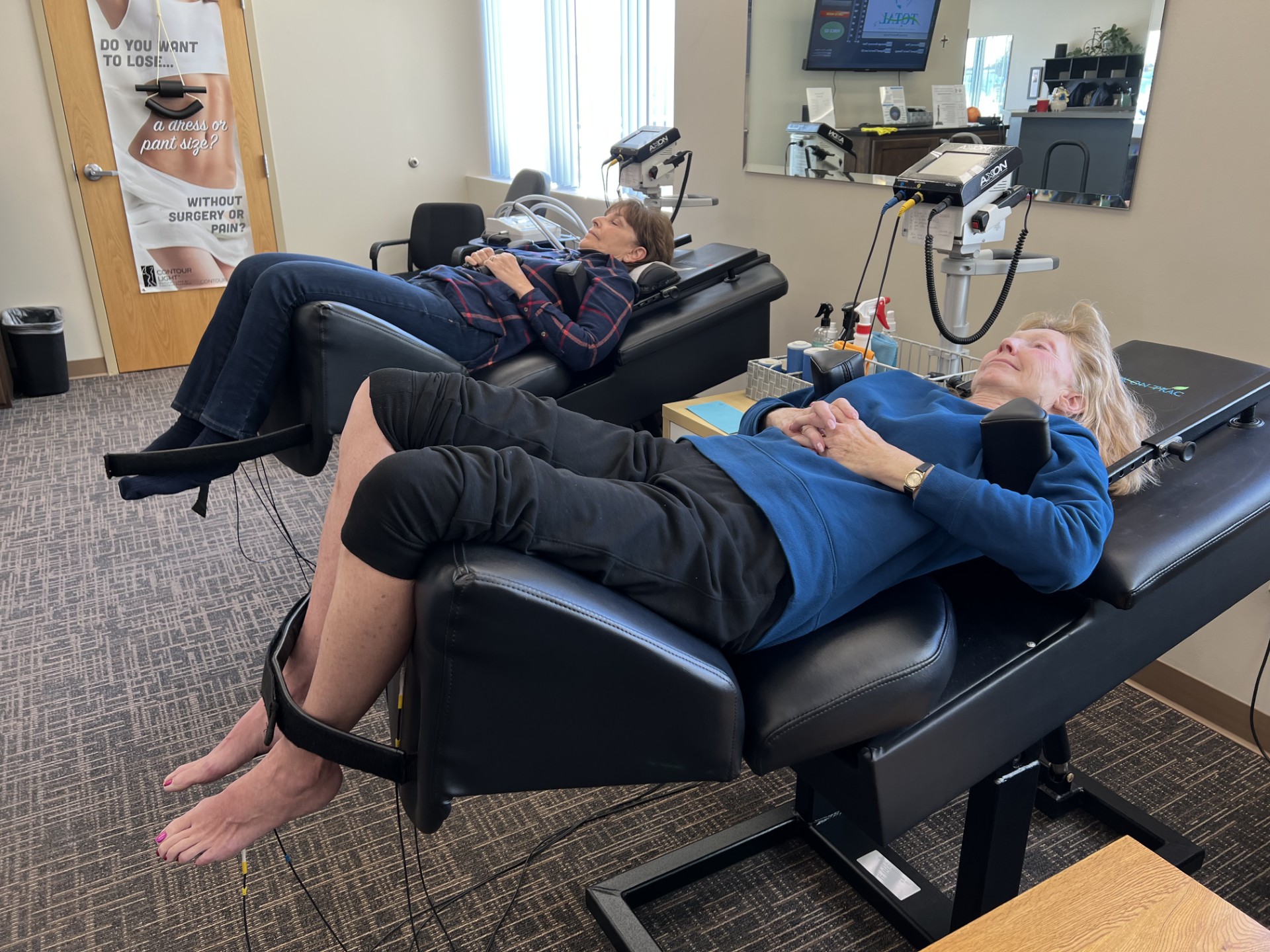 A close-up of a patient lying on a spinal decompression table, with a protective pad under their neck and a strap over their torso, highlighting a part of the treatment process for spinal issues.