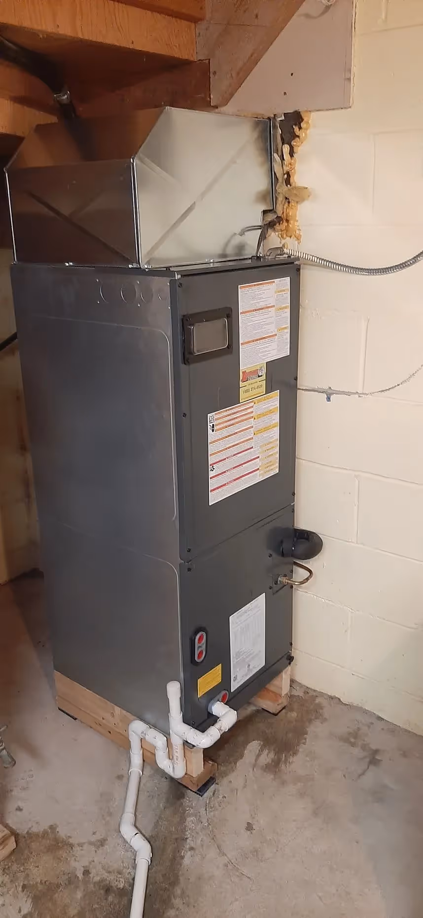 Large gray HVAC air handler installed against an interior wall.