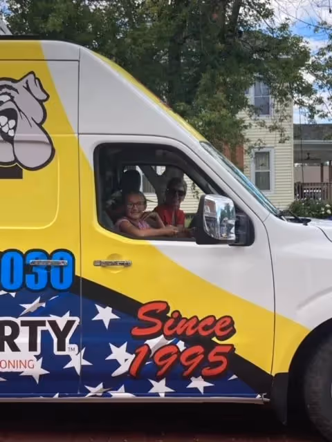 Side window of a service van showing passengers inside