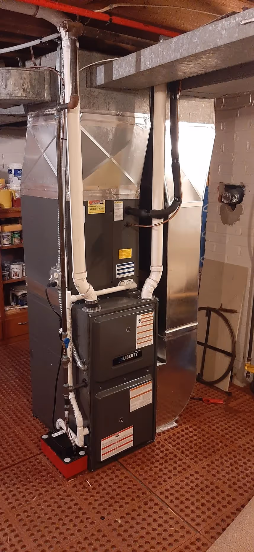 Installed furnace or air handler with ductwork and pipes
