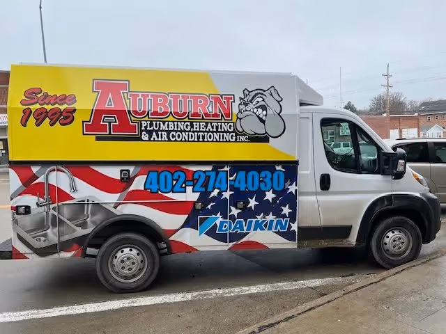 Aslan Mechanical service van with red, white and blue branding parked outdoors.