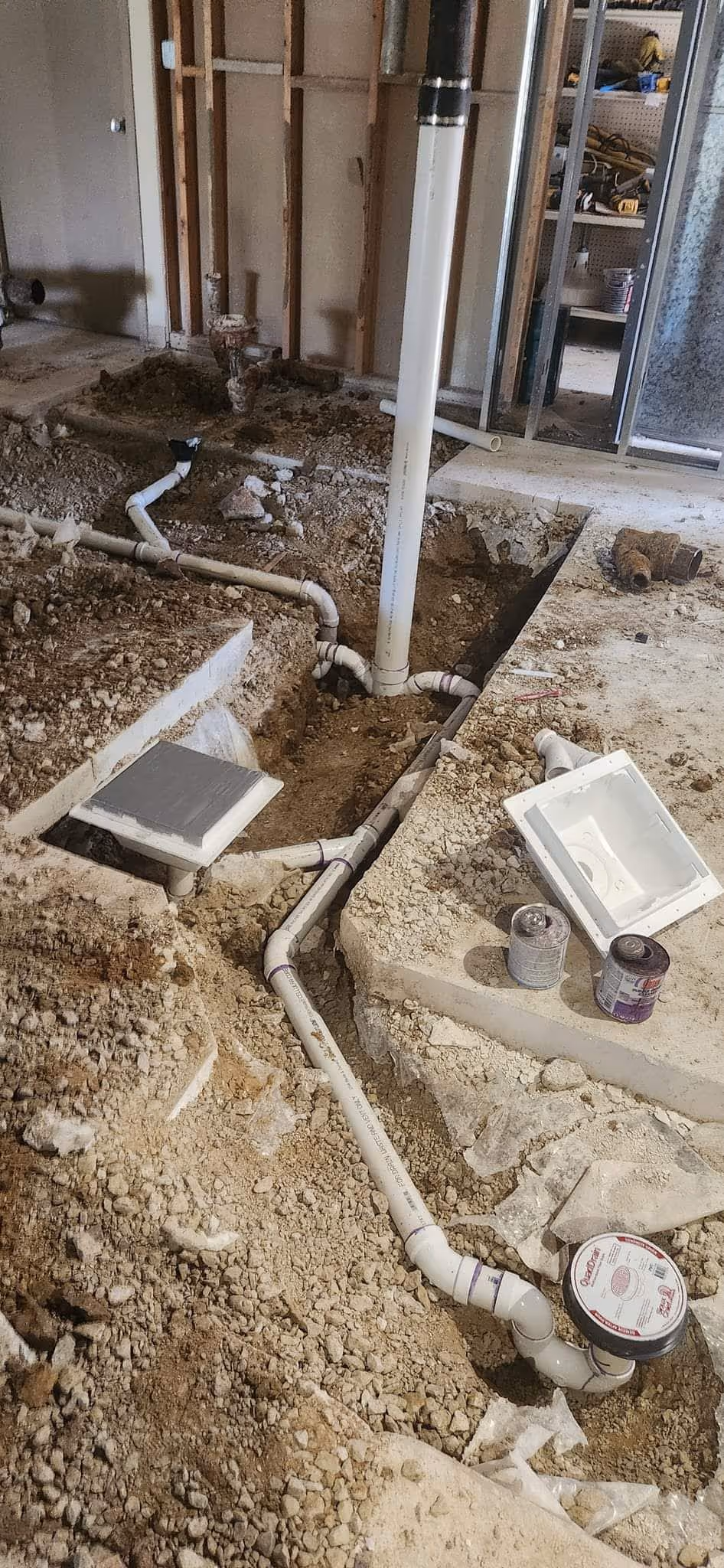 Vertical view of building interior ceiling featuring copper pipes and wiring