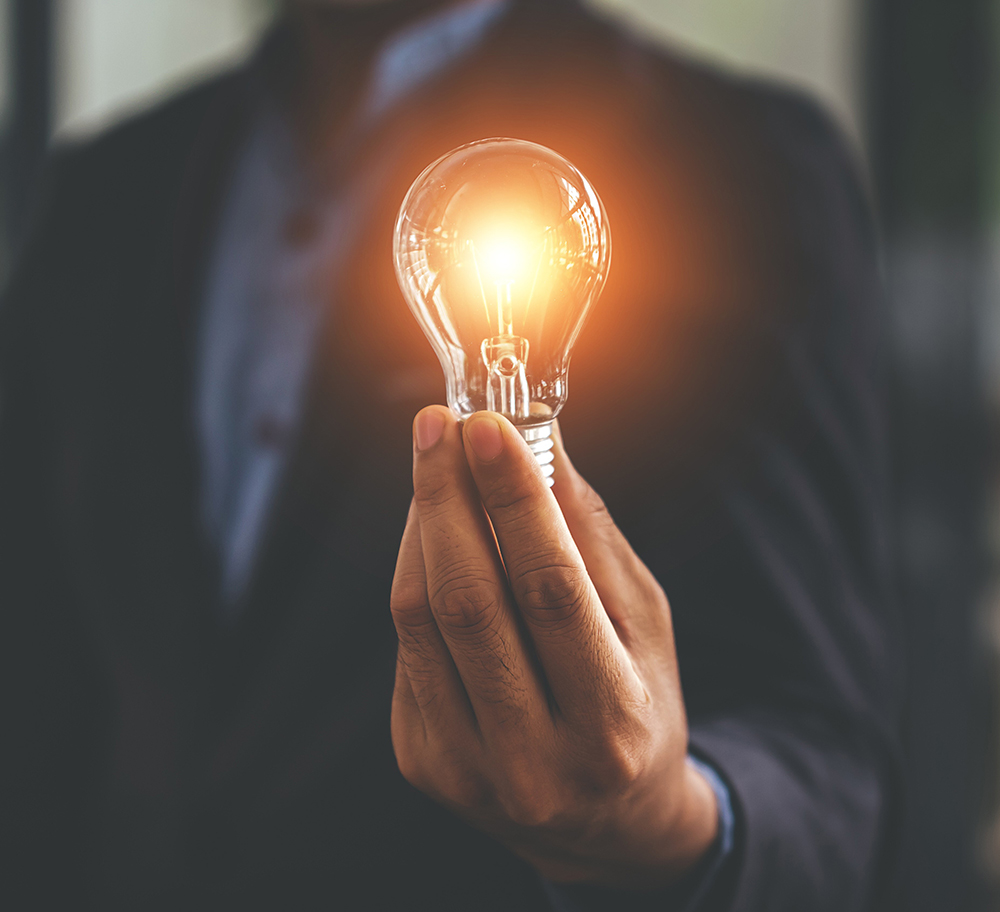 men holding a lightbulb