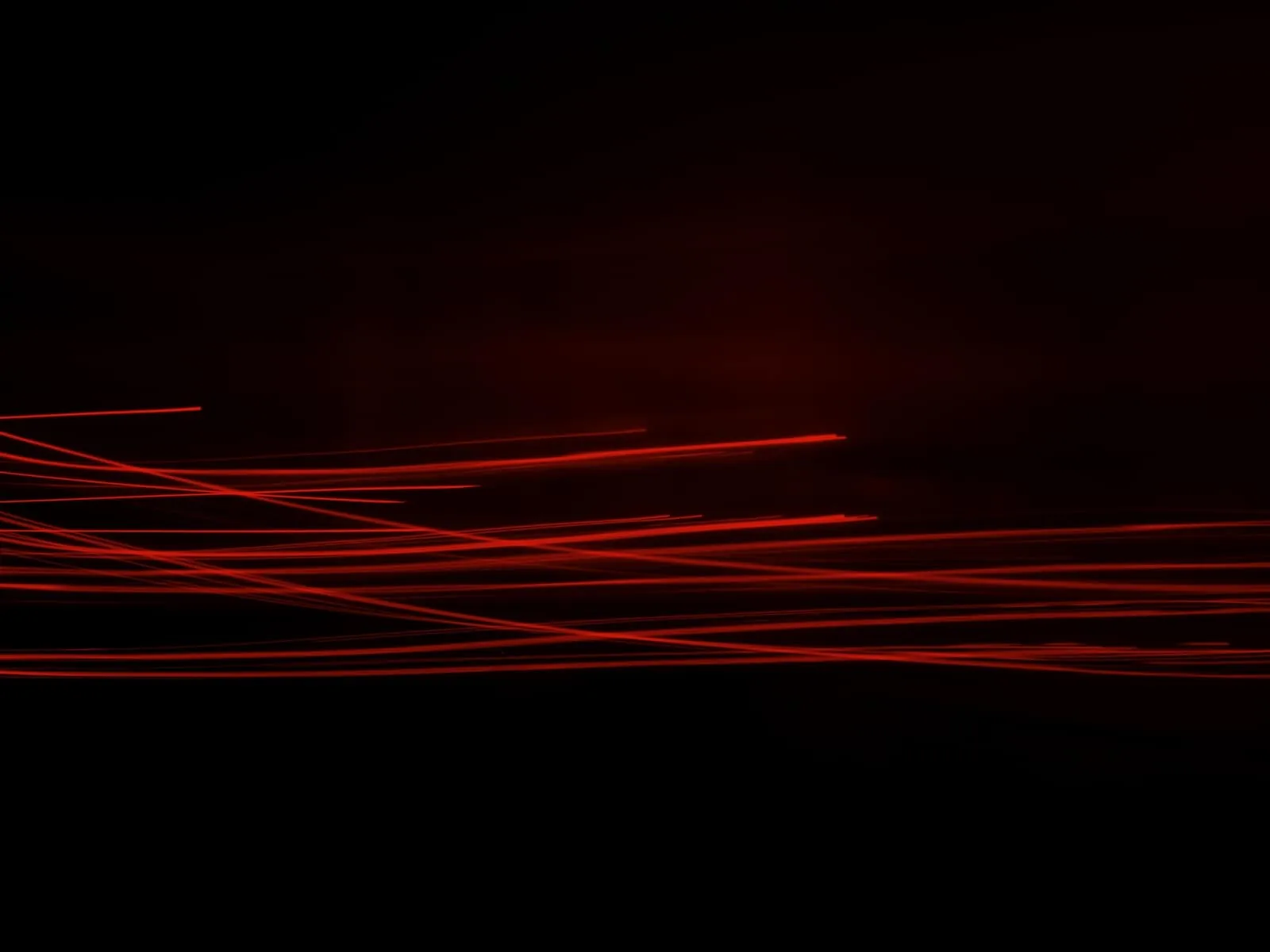 Black background with red laser lines 