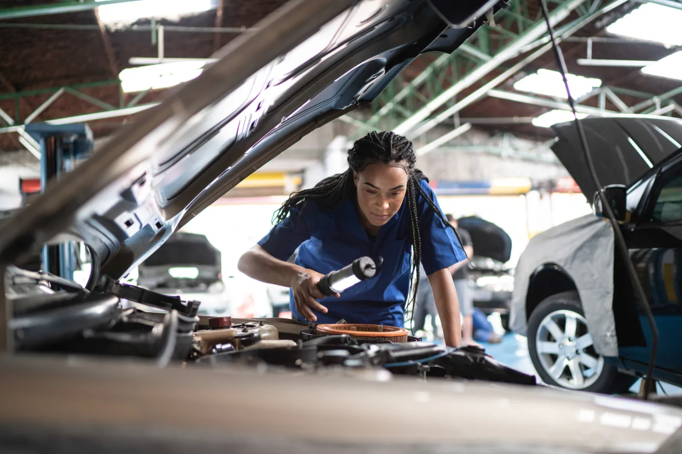 Woman inspecting a vehicle