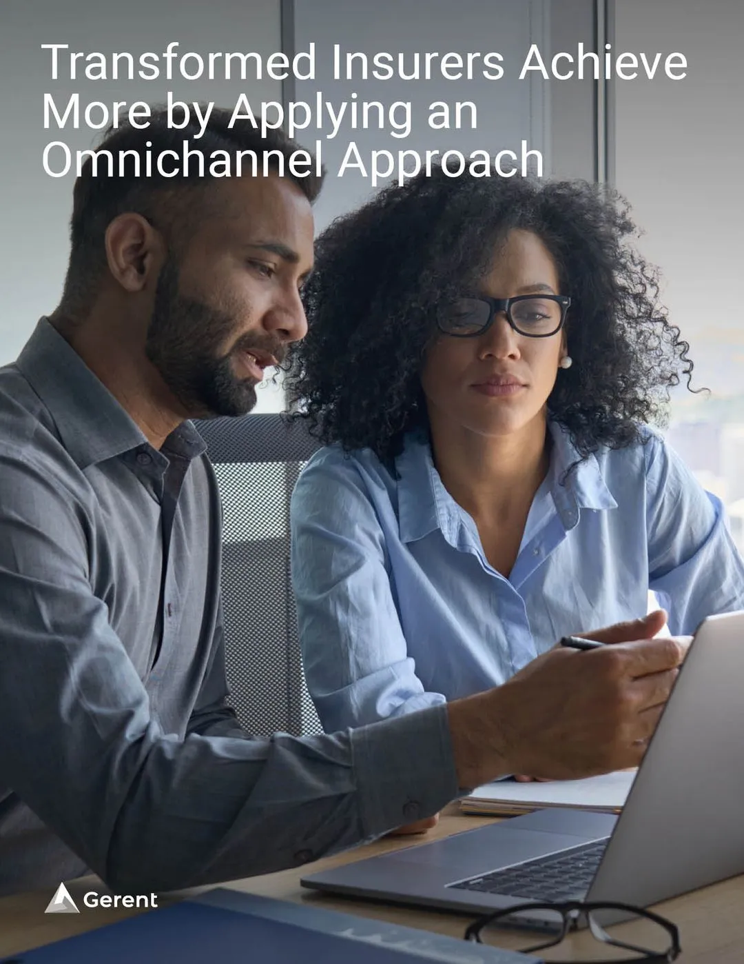 Two people discussing in front of a laptop
