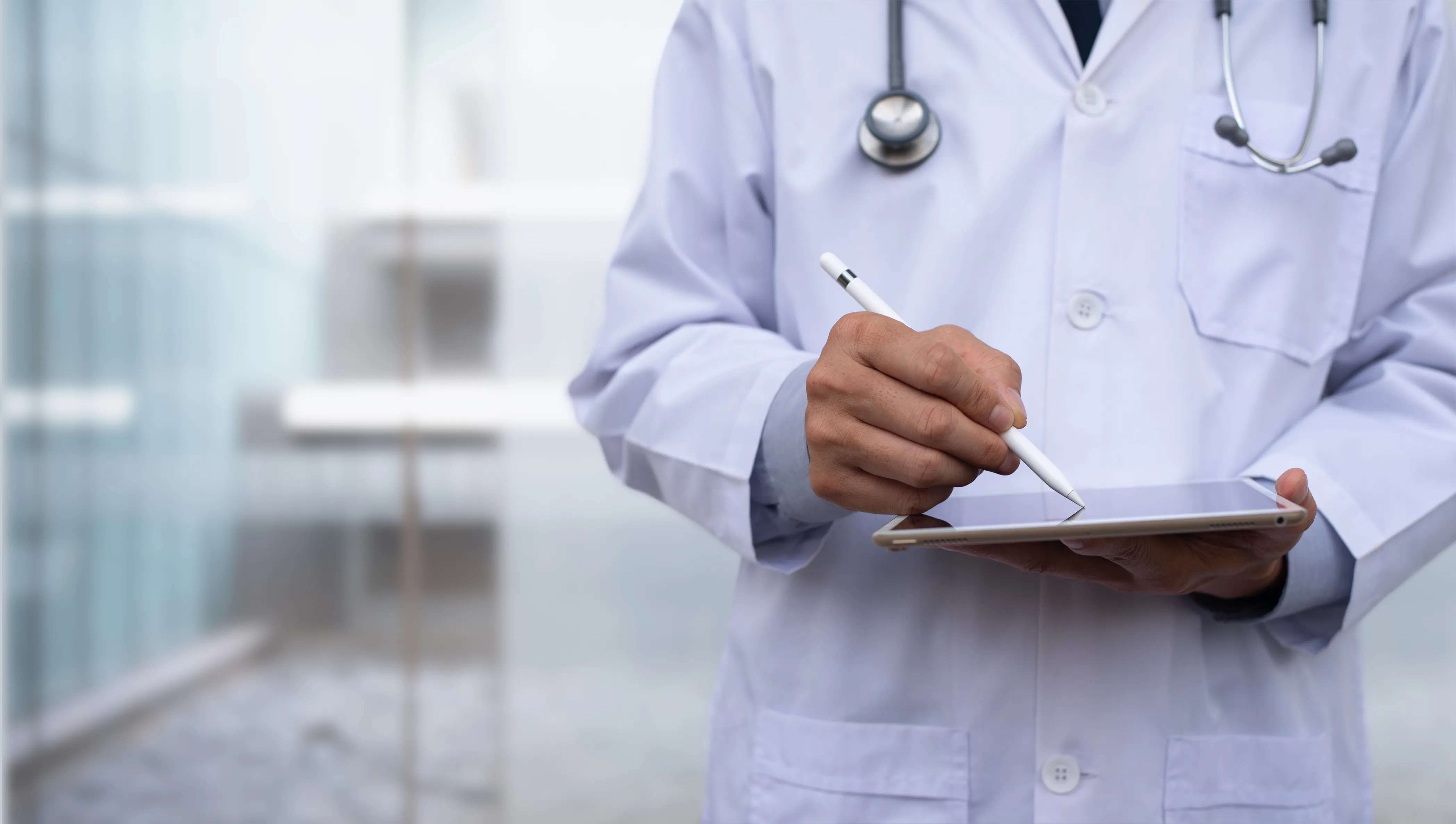 Medical professional taking notes on their tablet