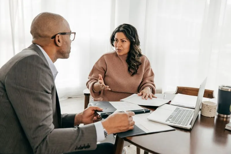 Man and women sitting at table having a conversation