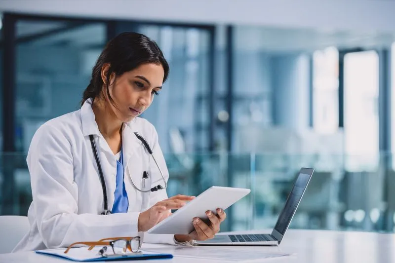 healthcare worker looking at electronic