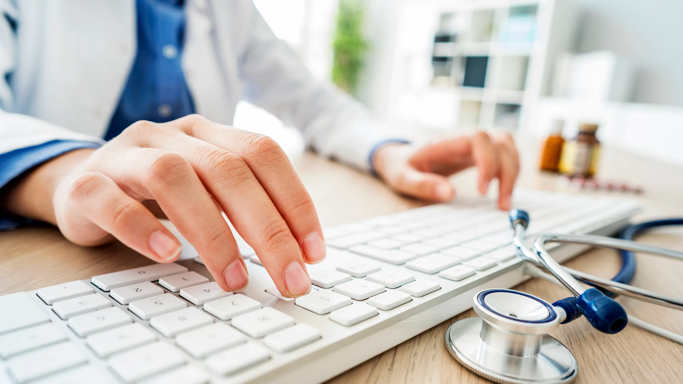Medical Professional Typing on Computer