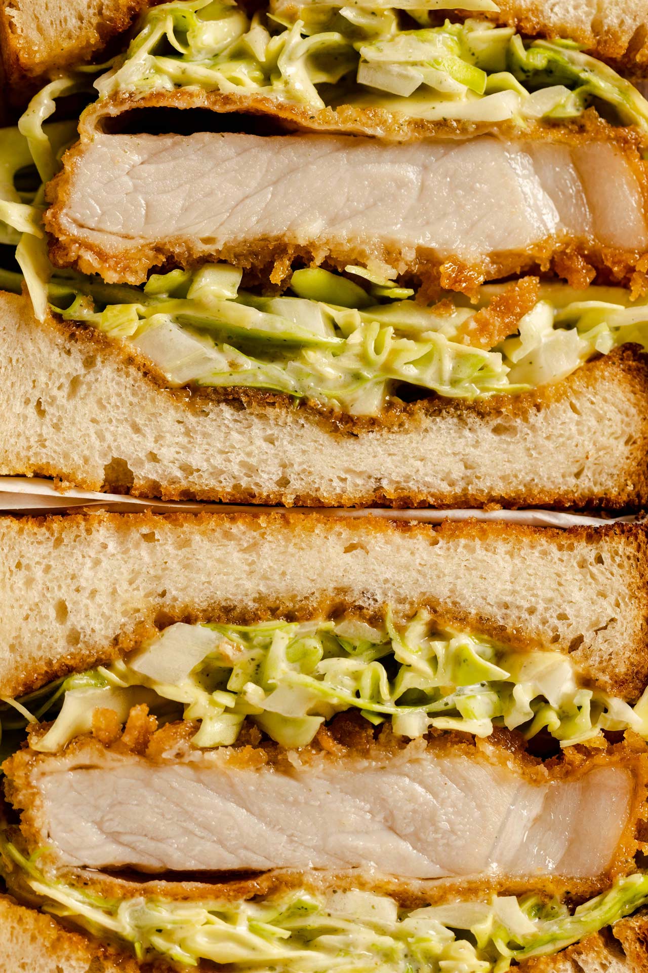 Close-up of a chicken sandwich cut in half.