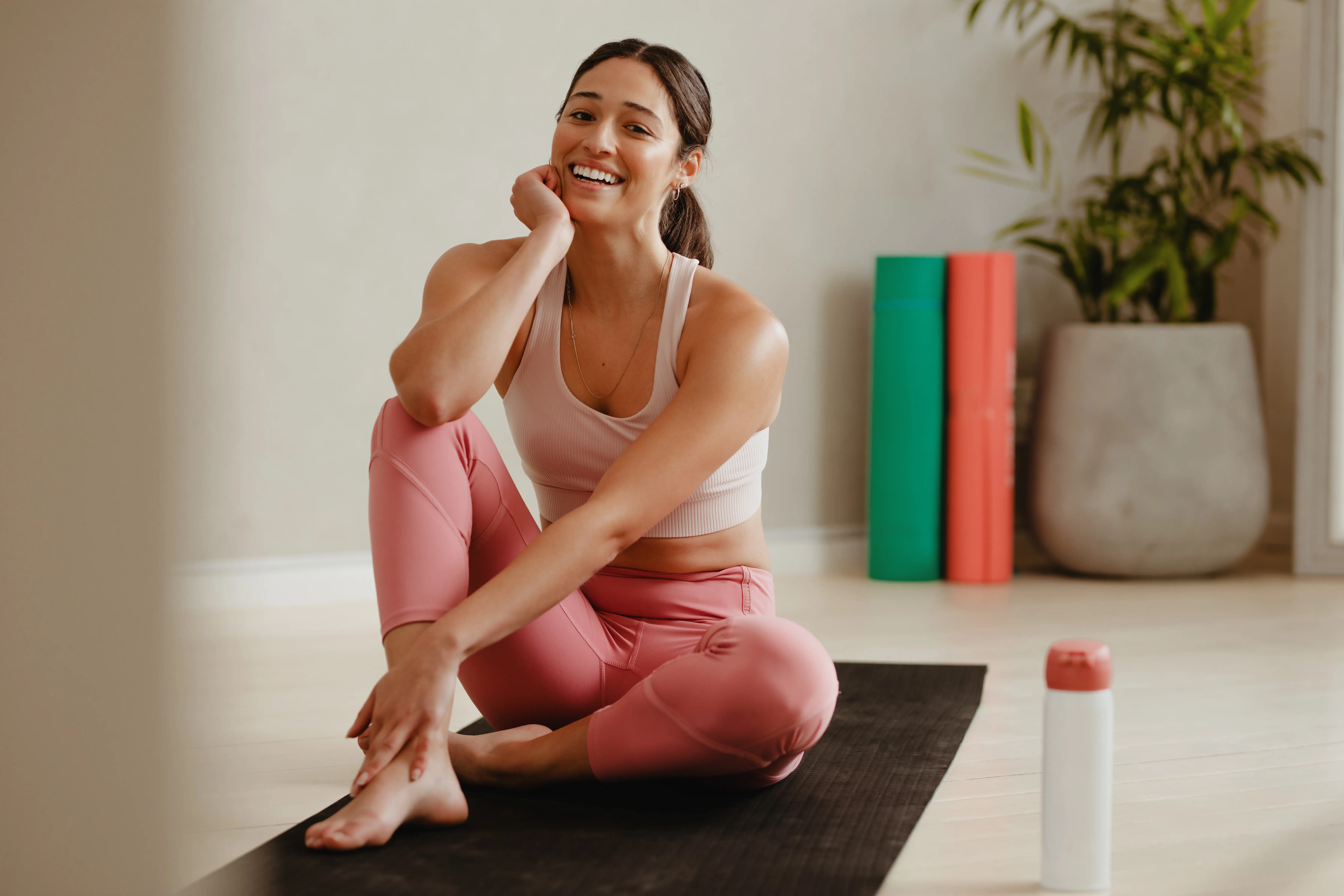 woman smiling on yoga mat