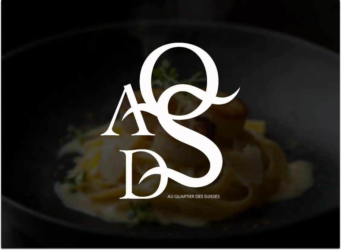 Restaurant logo 'AQDS' with text 'Au Quartier Des Suisses' over a blurred dish in a dark bowl.