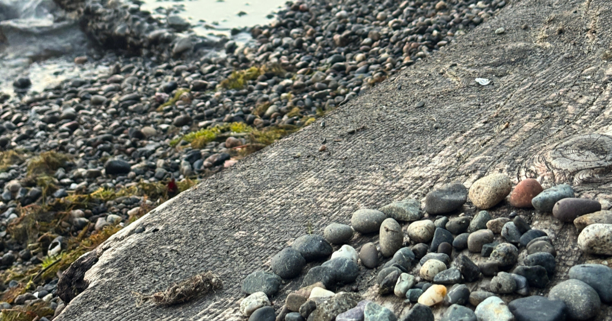 Spiral of river rocks next to a river