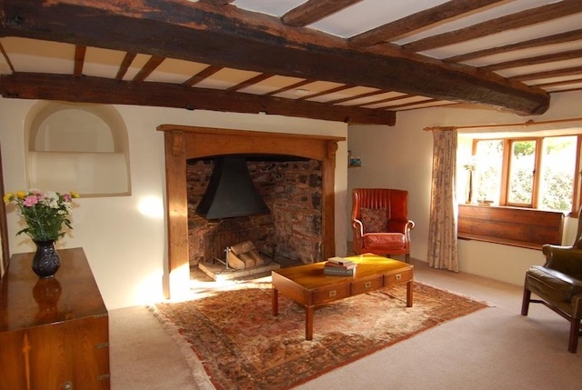 The living room showcases a fireplace and a beautiful wooden floor.