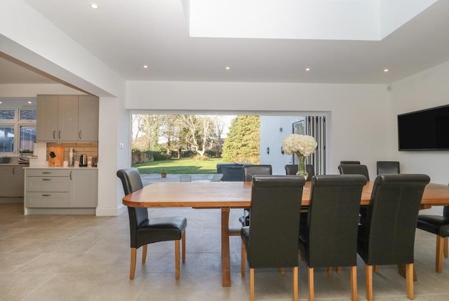 Stylish holiday home dining area with sliding doors opening to outdoor space.