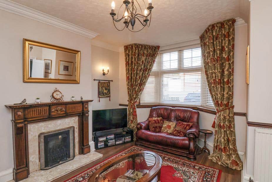 Cottage living room with ornate wood fireplace