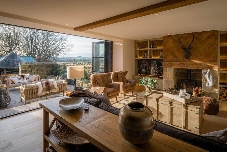 Living room with wood burner and open patio seating area