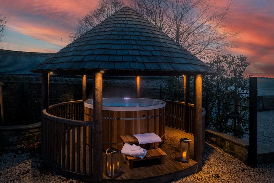 Cottage garden gazebo with wooden hot tub and steps