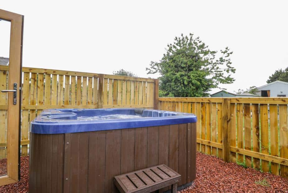 Cottage garden with hot tub and wooden fence