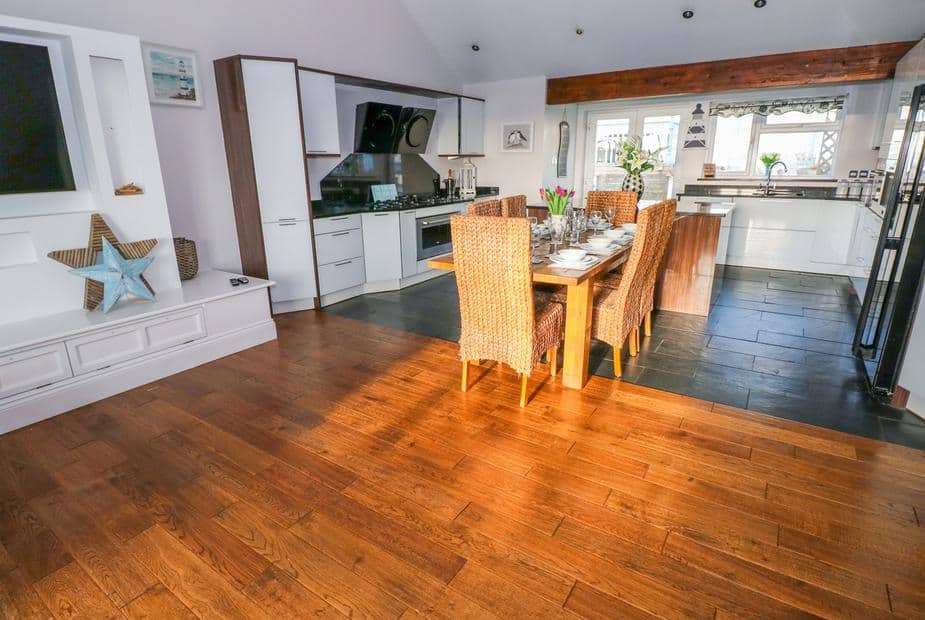 Cottage kitchen and dining area with wooden table and wicker chairs