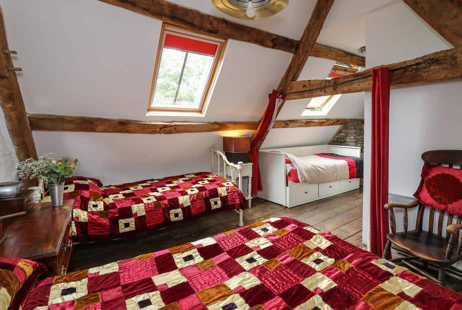 Cottage bedroom with twin beds, skylights and exposed wooden beams