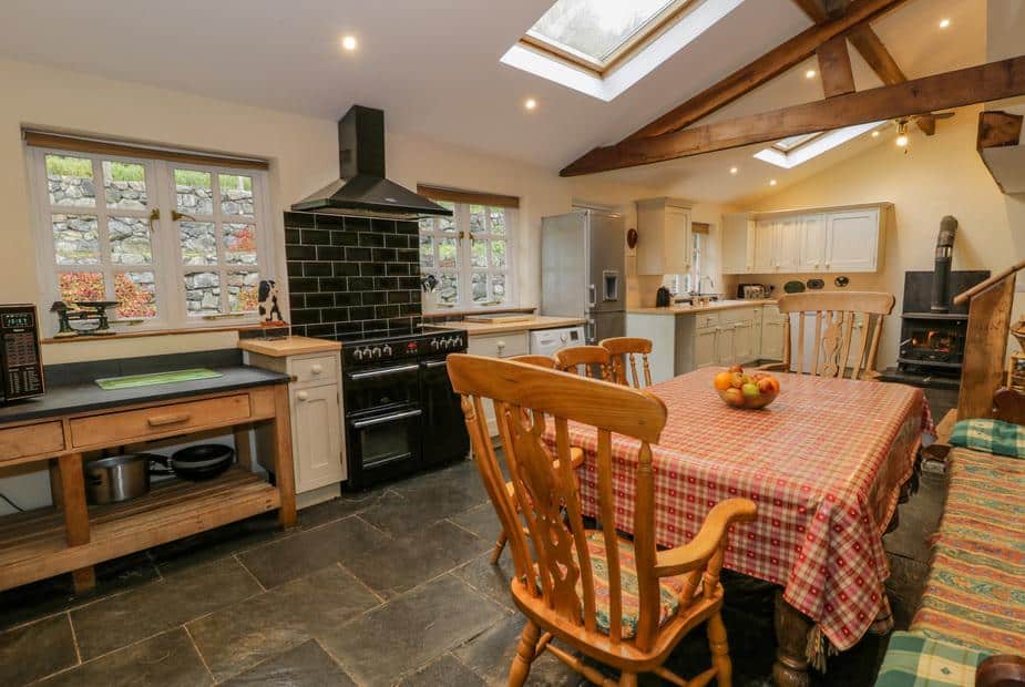 Cottage kitchen with dining table, range cooker and exposed wooden beams