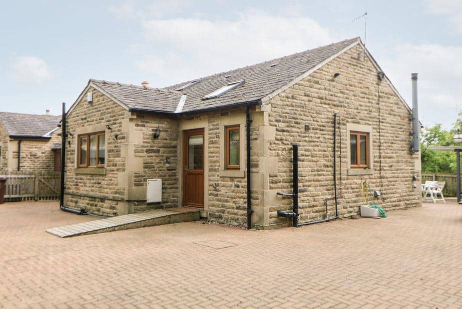3 Pheasant Lane stone cottage with ramped entrance and paved courtyard