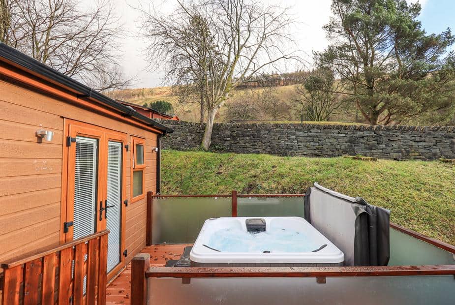 Lodge decking area with hot tub and hillside view