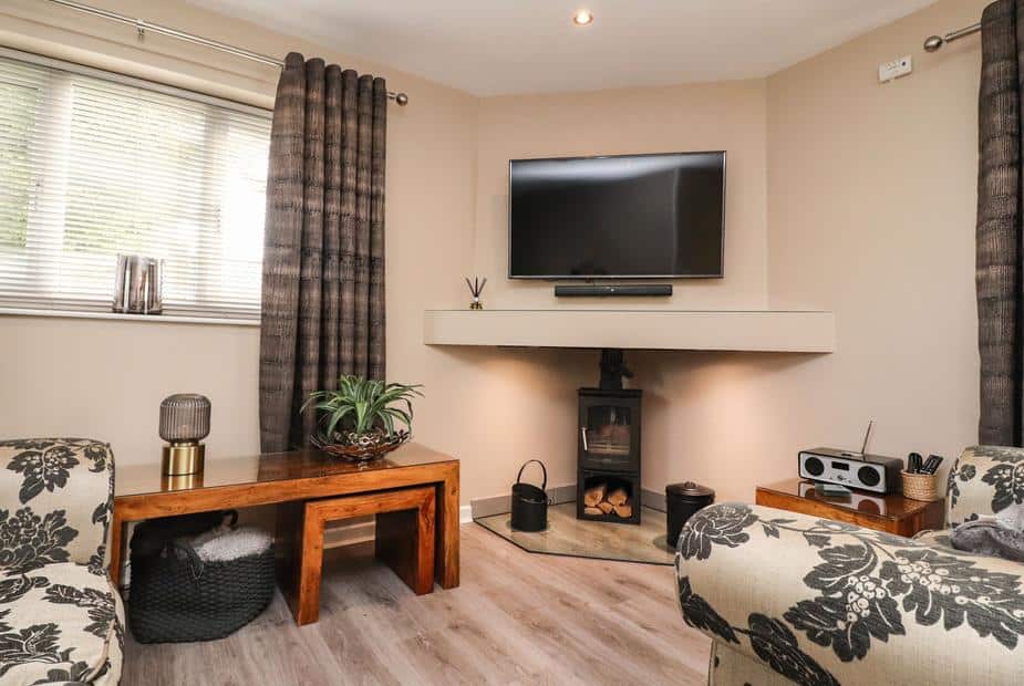 Lodge living room with wood-burning stove and wall-mounted TV