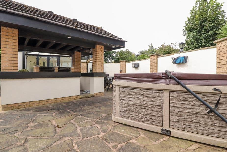 Cottage patio with hot tub and outdoor bar area