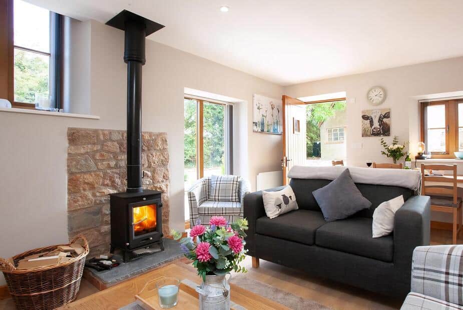 Cottage lounge with log burner and grey sofa