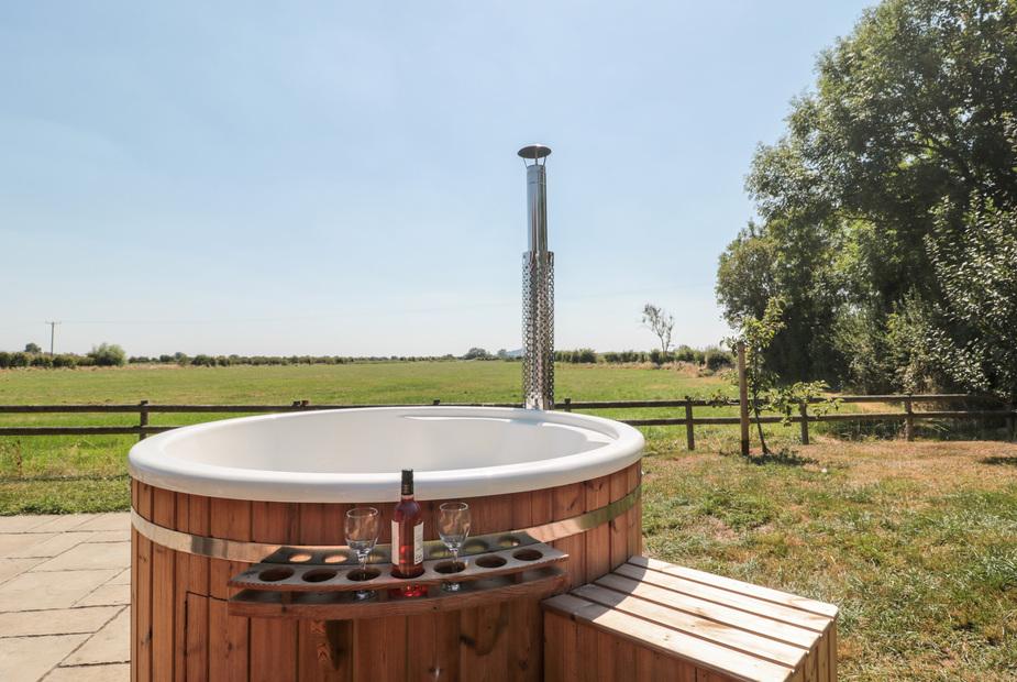 Lodge with outdoor hot tub and countryside view