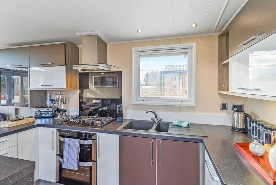 Lodge kitchen with gas hob, oven, and window above sink