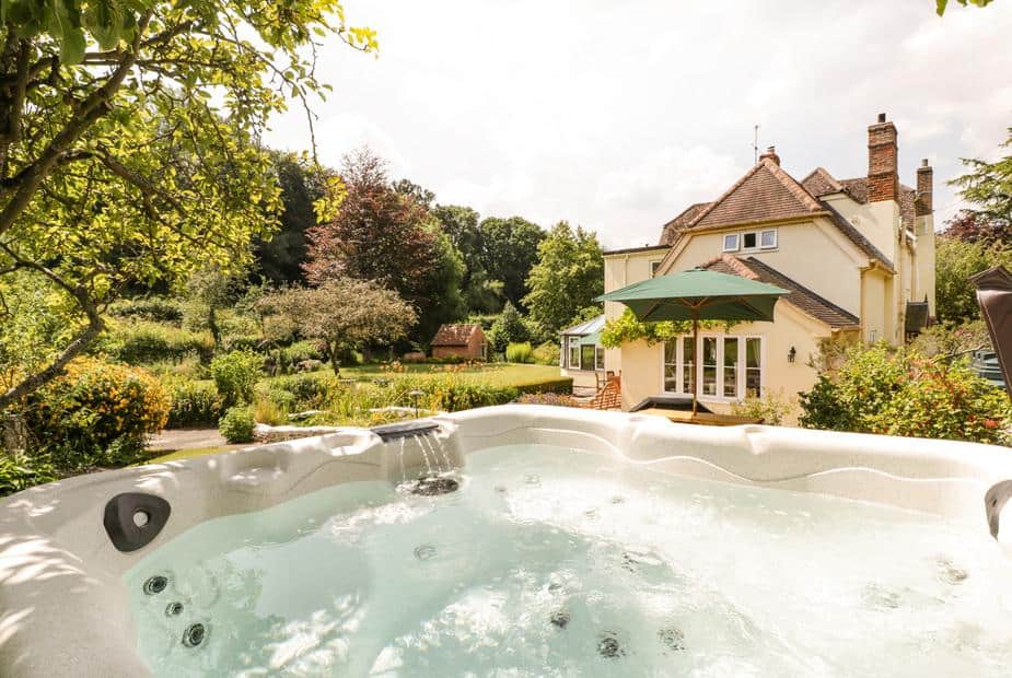 Cottage garden with outdoor hot tub and patio area
